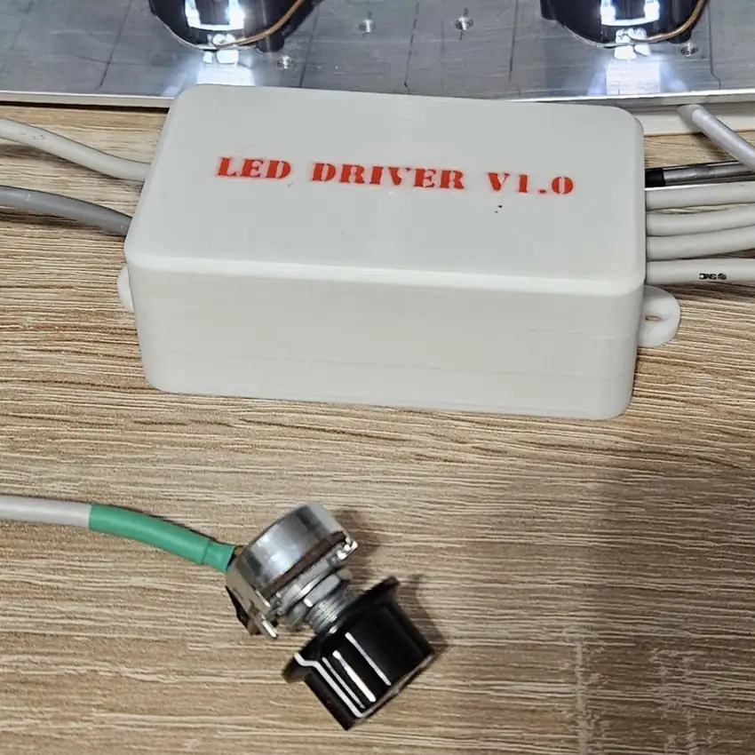LED driver in a white enclosure with cable outlets and an adjuster
