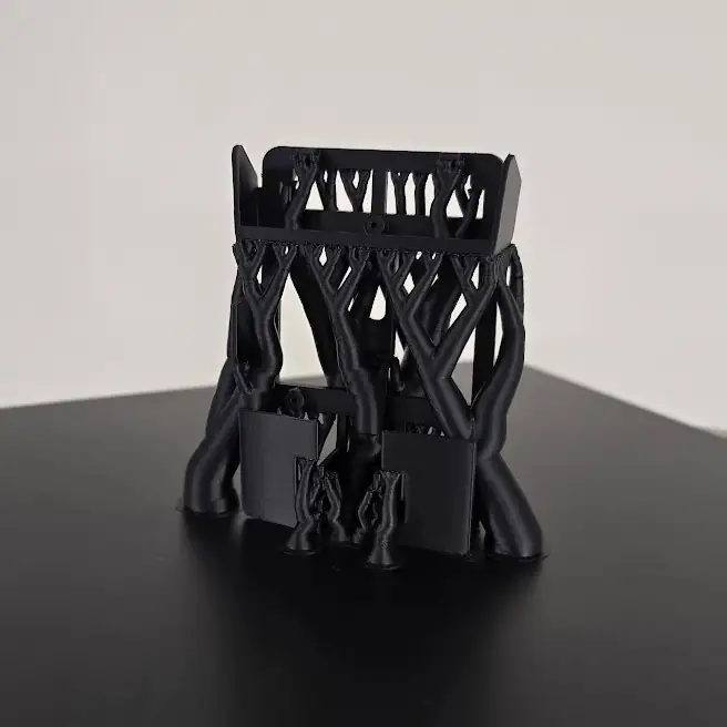 Black 3D printed part with supports on the build plate