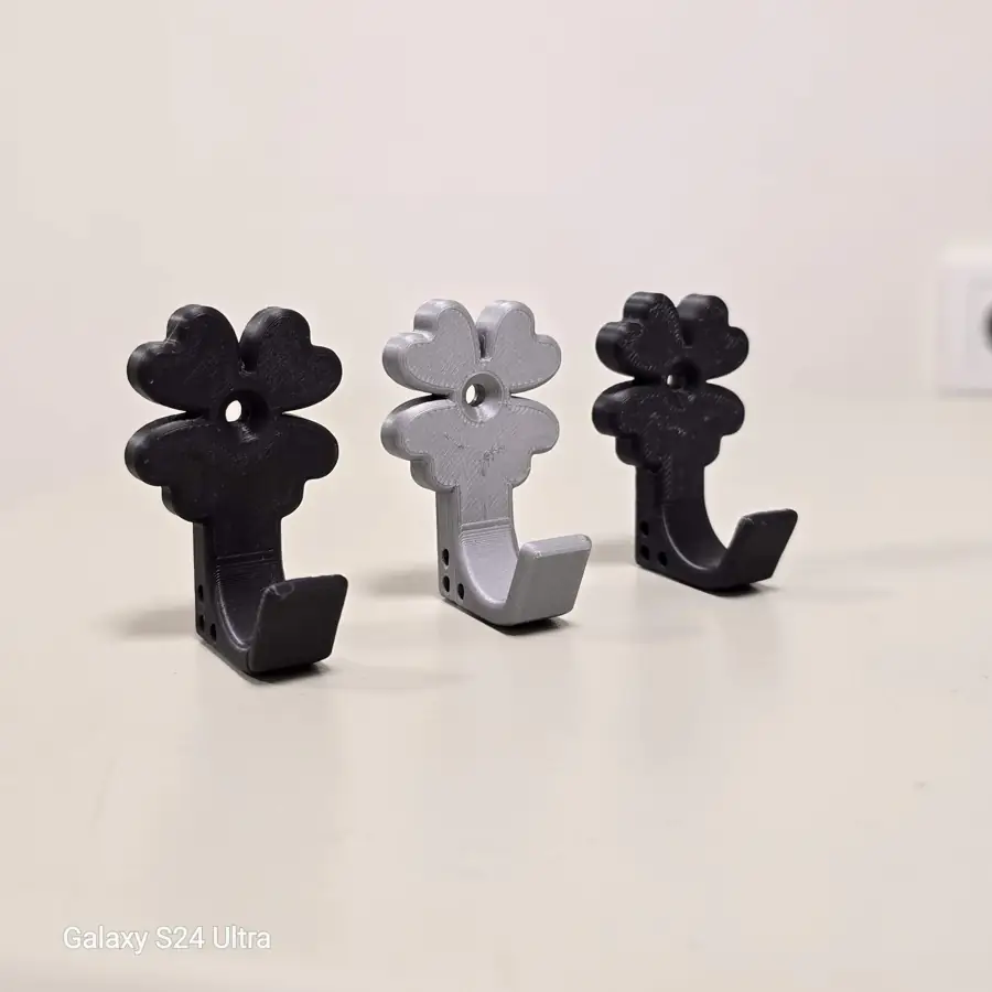 Three versions of 3D printed hooks in black and gray