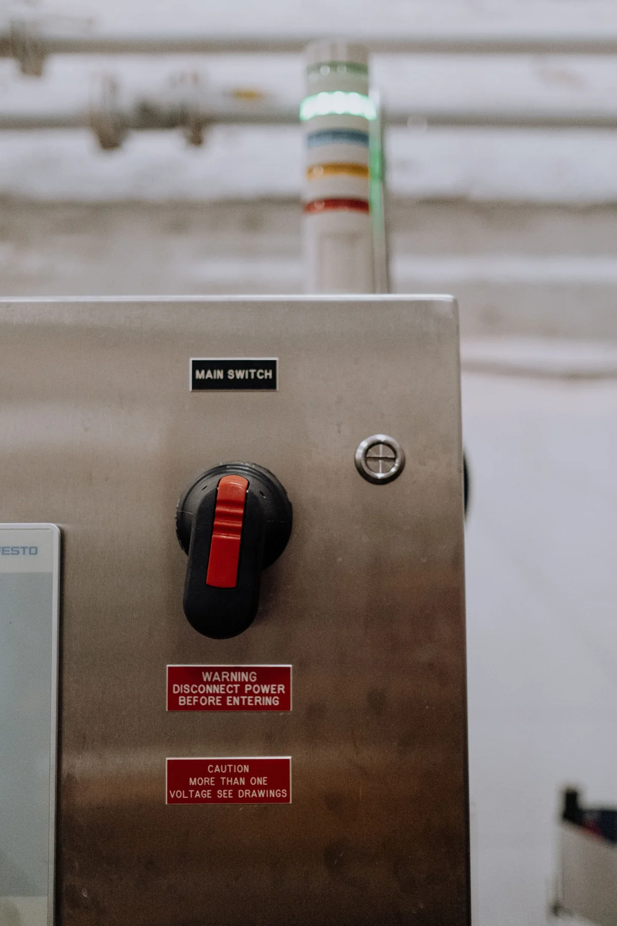 Industrial cabinet with main switch and warning labels